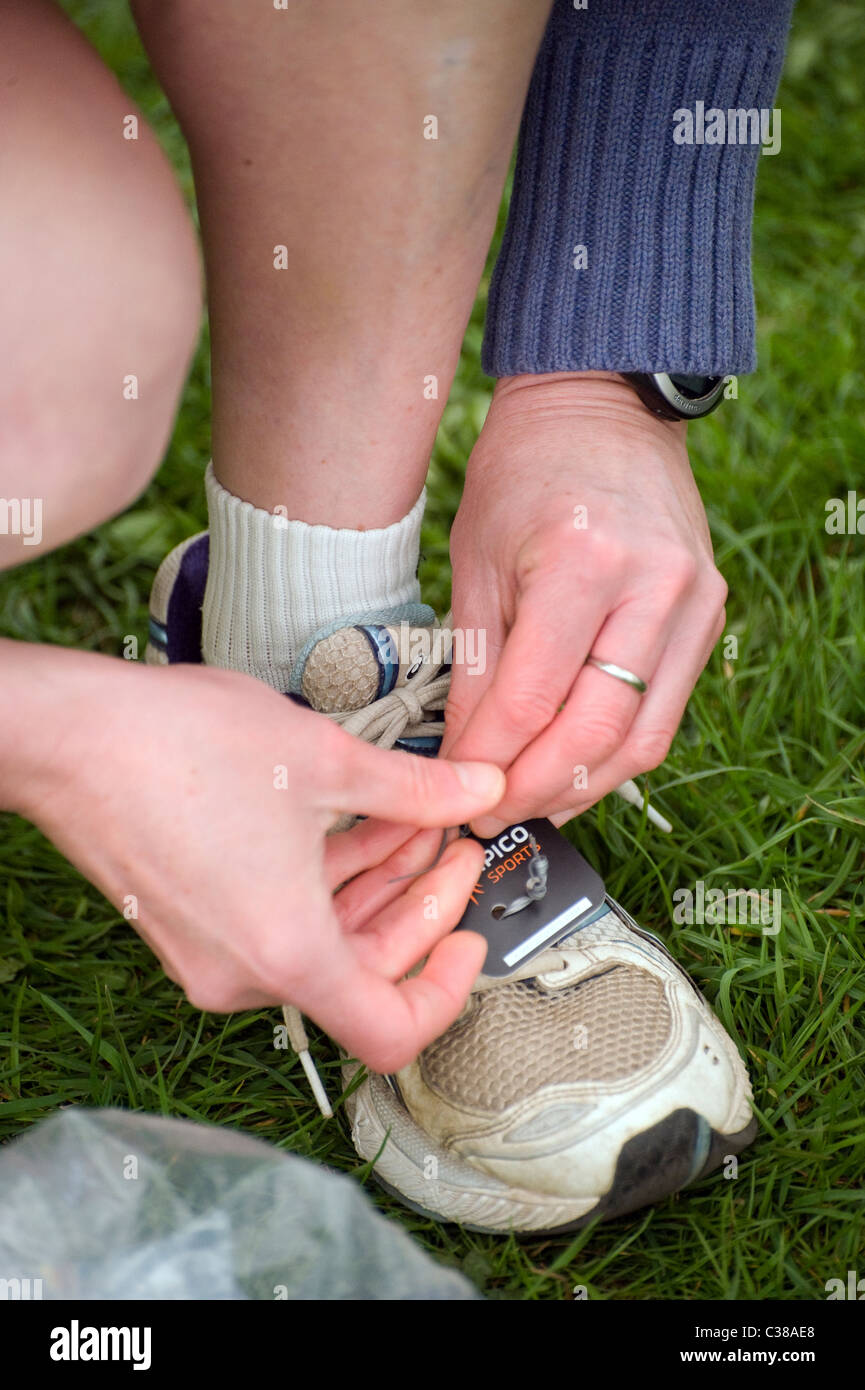pinning on electronic timing tag to running shoe Stock Photo