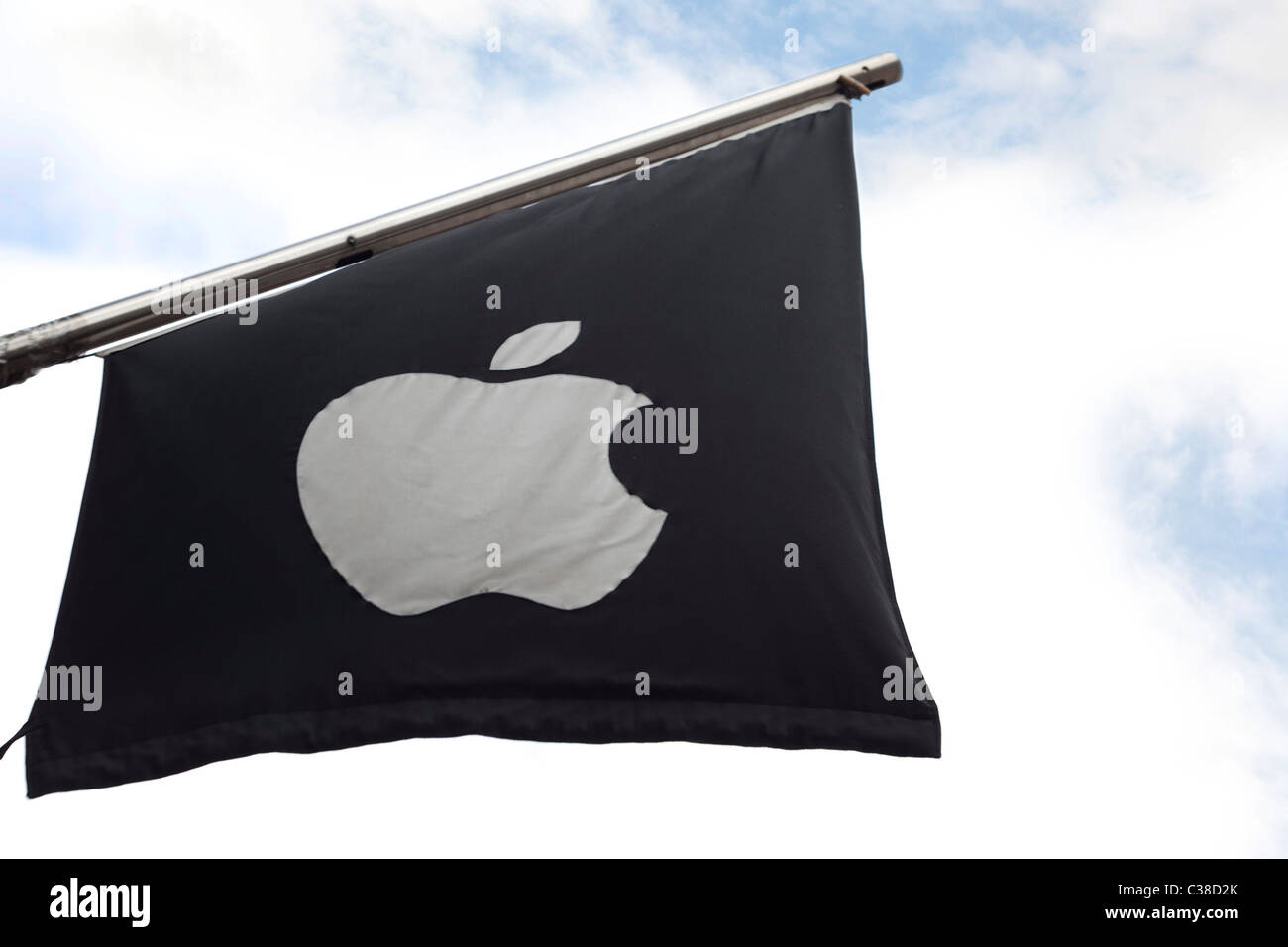 An Apple branded flag outside an Apple store. Stock Photo