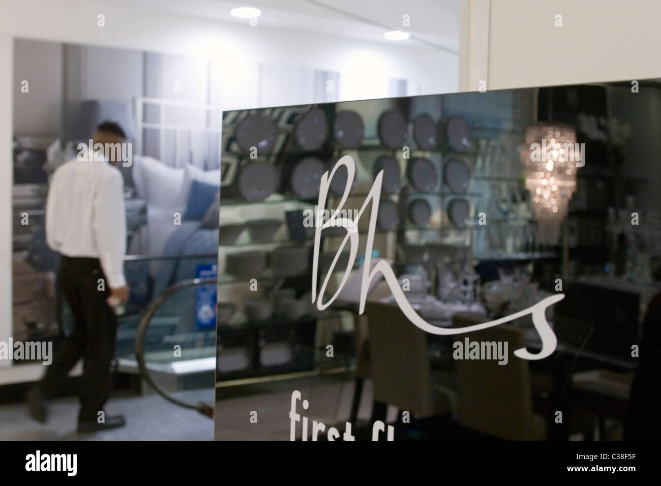 A member of staff inside the BHS store on Oxford Street, London. Stock Photo
