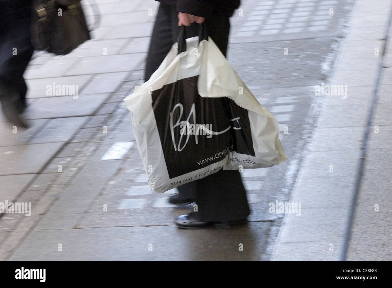 A BHS customer leaves the Oxford Street store having made a purchase. Stock Photo
