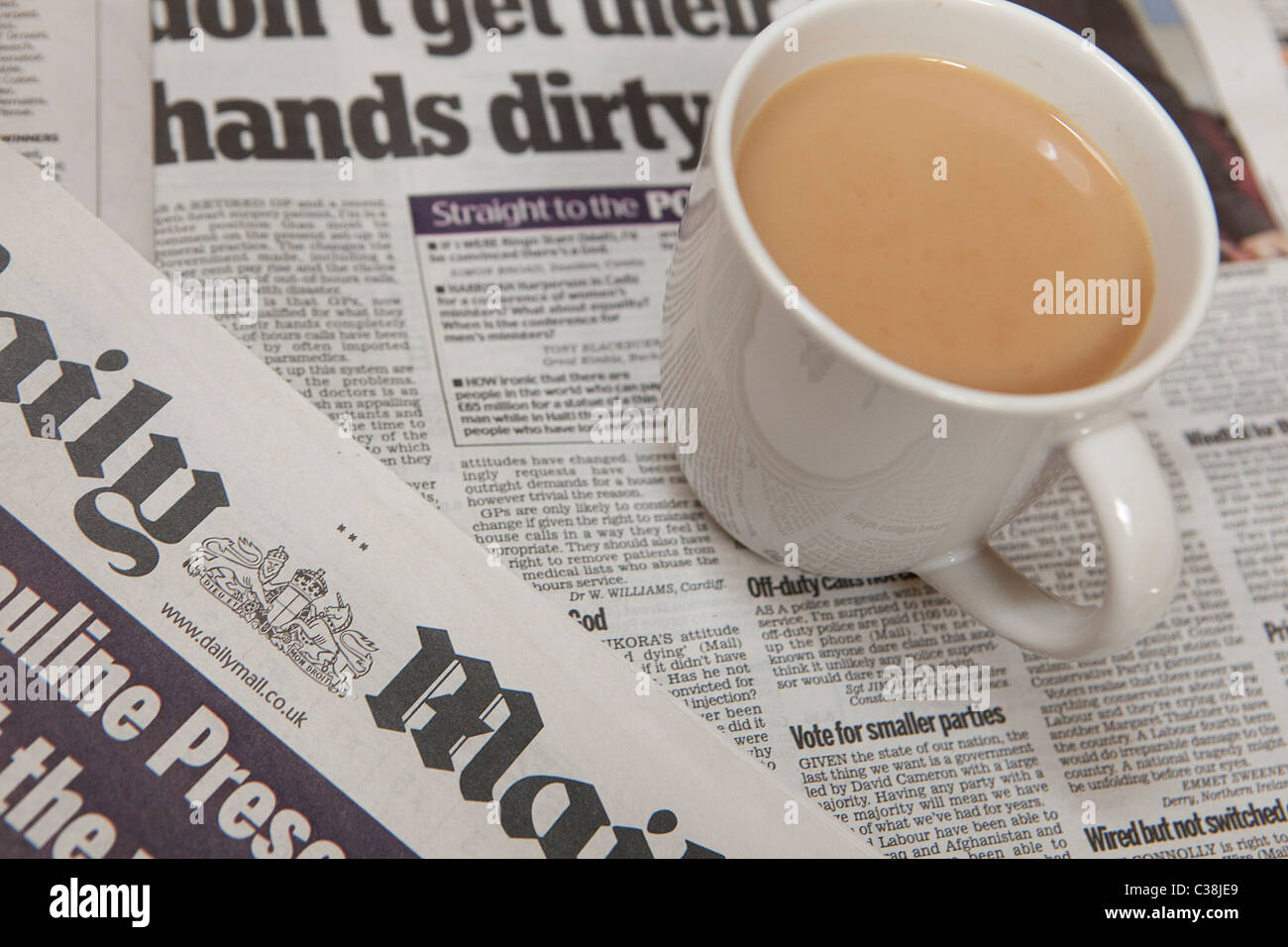 Daily Mail Newspaper beside a cup. Stock Photo