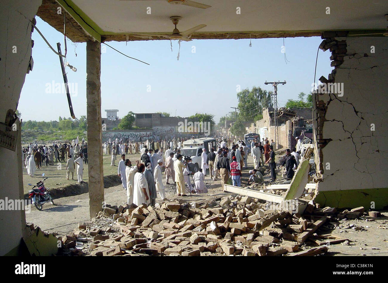 People gather at the site of explosion after bomb explosion in Charsadda District on Monday, May 02, 2011 Stock Photo