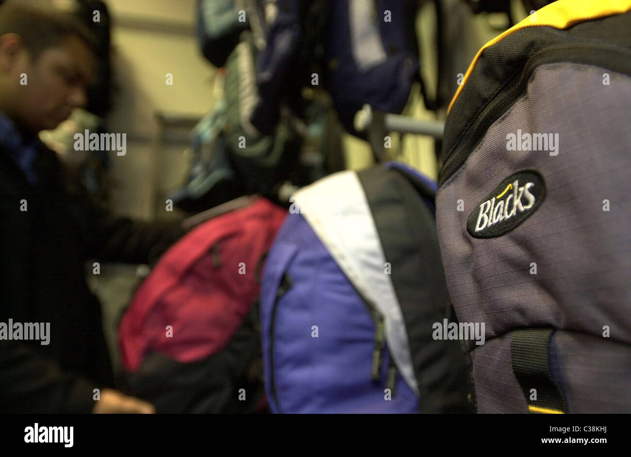 A customers browsing the backpacks sections in a Blacks store Stock Photo