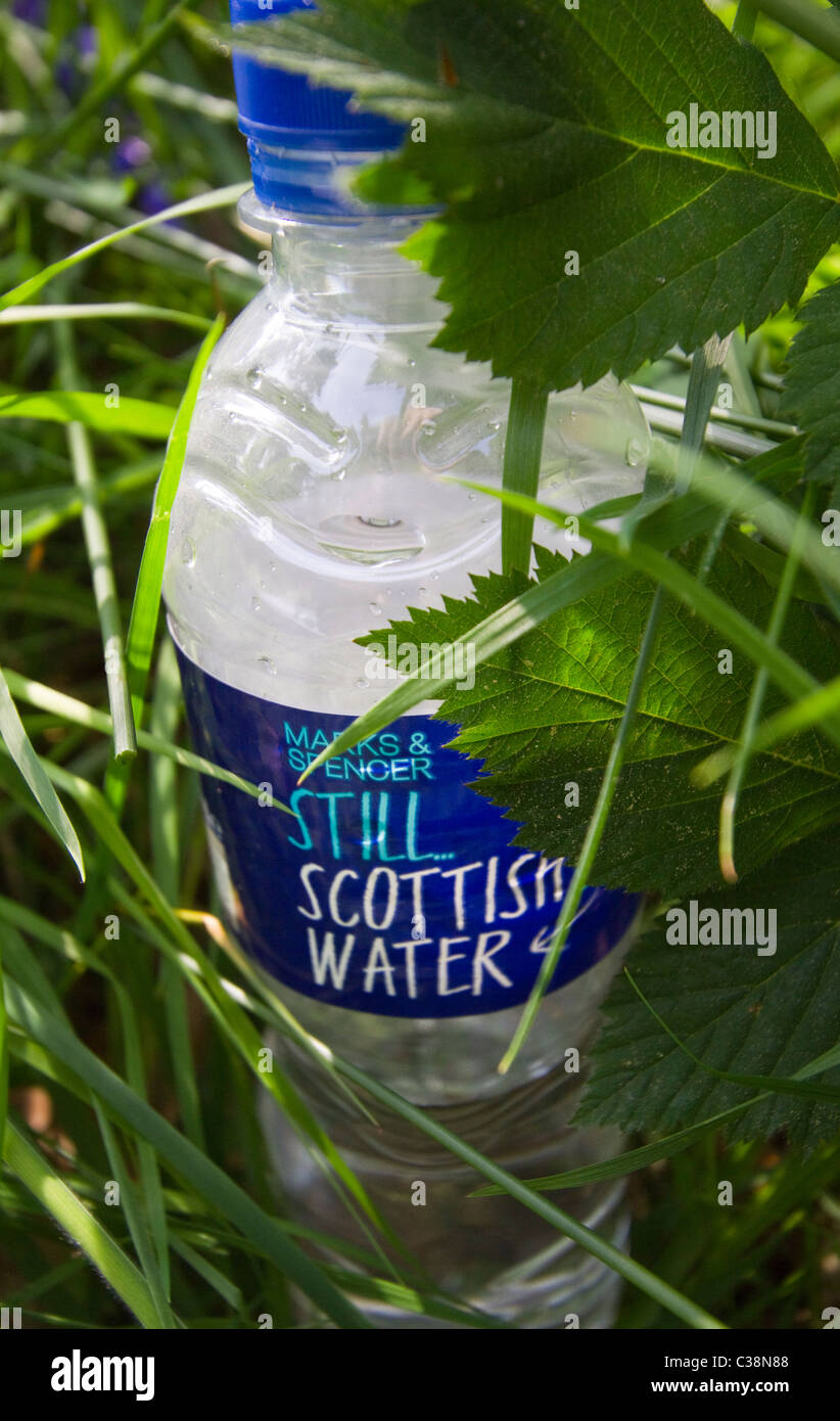 Plastic bottle fresh water dropped in lush green grass Stock Photo - Alamy