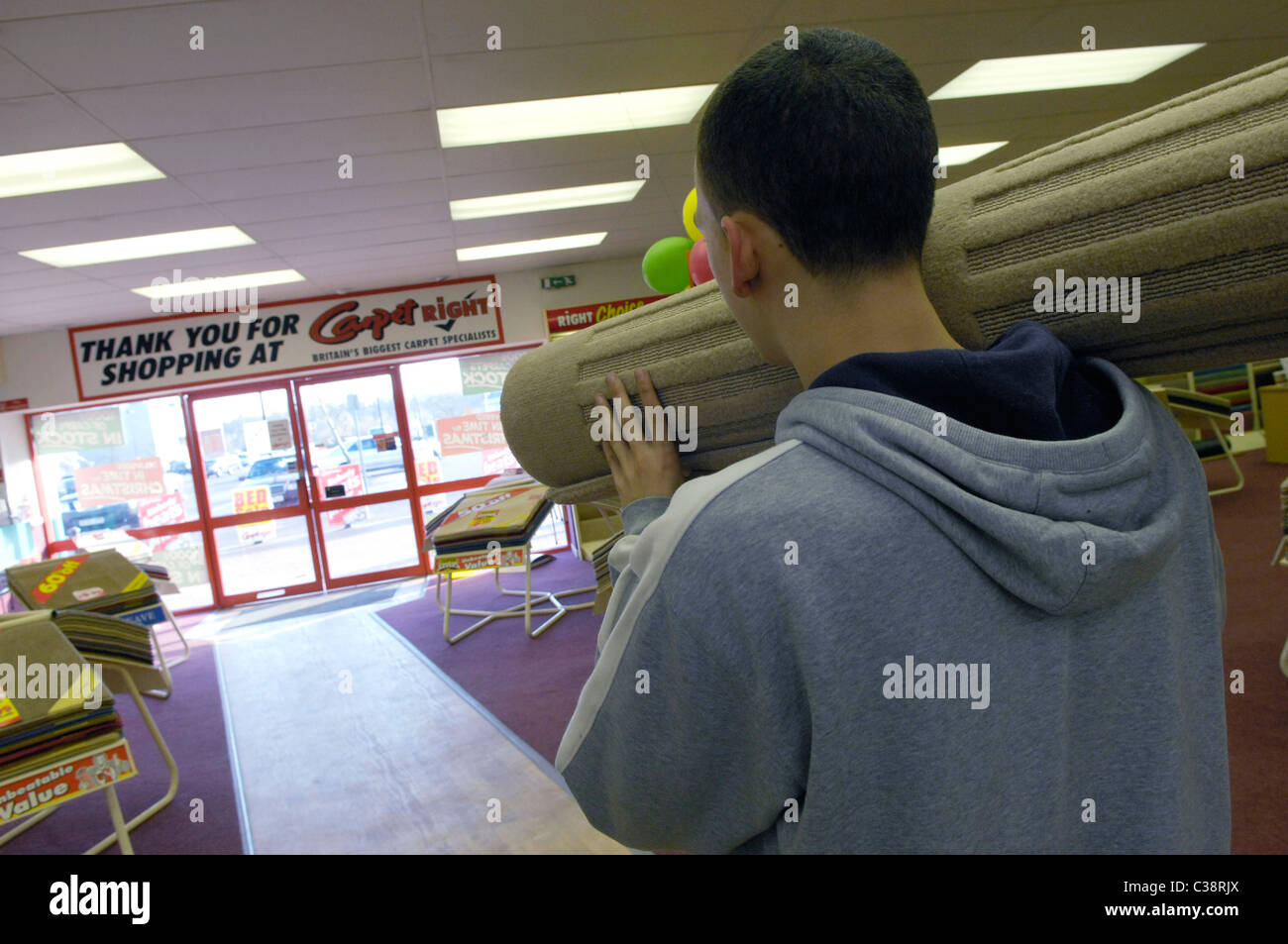Carpet Right A Customer carrying his purchase through a Carpet Right