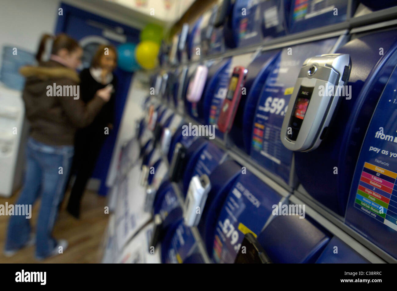 A Carphone Warehouse employee advising a customer inside a store. Stock Photo