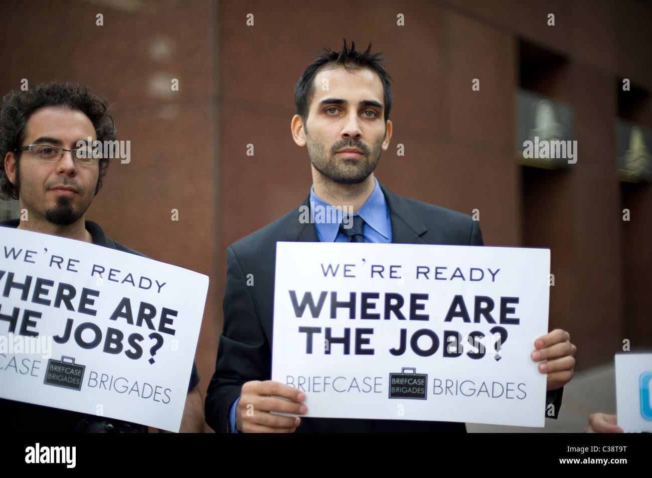 Members of the Briefcase Brigades and their supporters protest in front of New York Senator