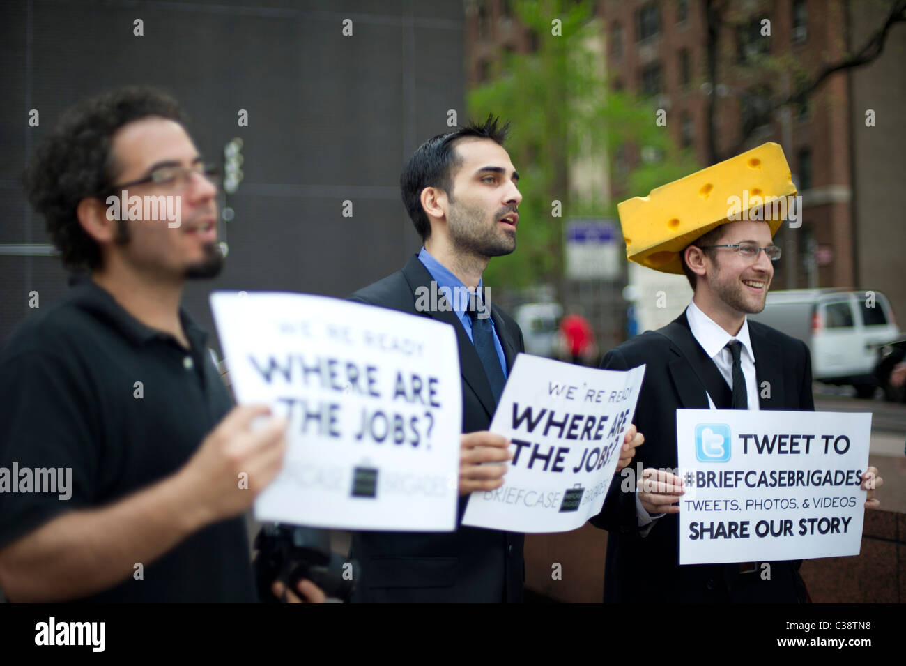 Members of the Briefcase Brigades and their supporters protest in front of New York Senator