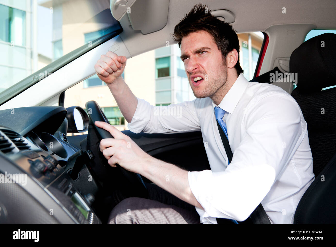Man gesturing whilst driving car Stock Photo