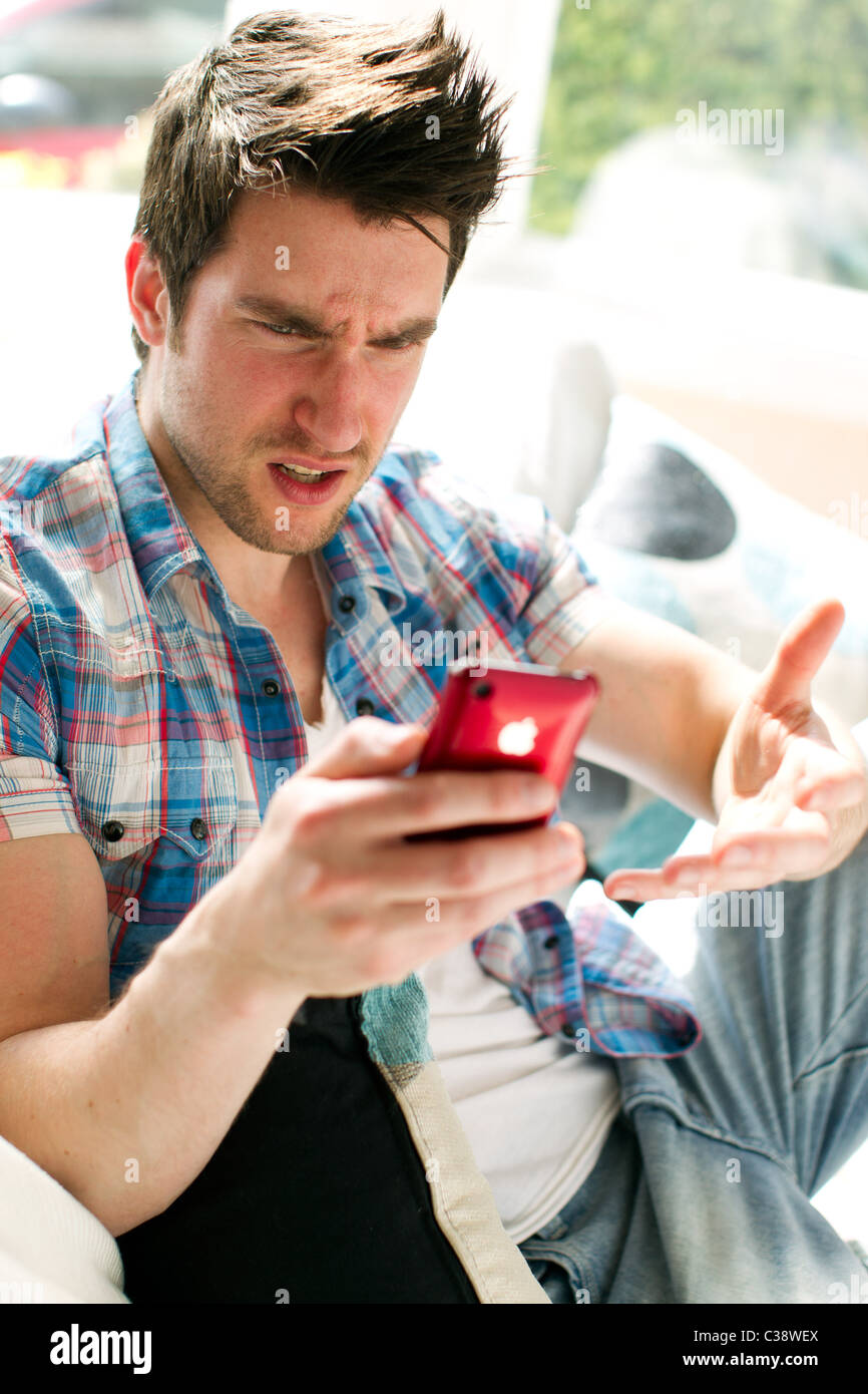 Man annoyed at received message Stock Photo