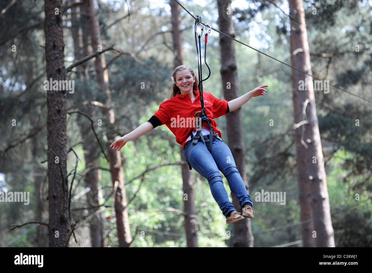 Young Girl Riding The Zip Wire At Go Ape In Swinley Forest Near Bracknell England Uk Stock Photo Alamy