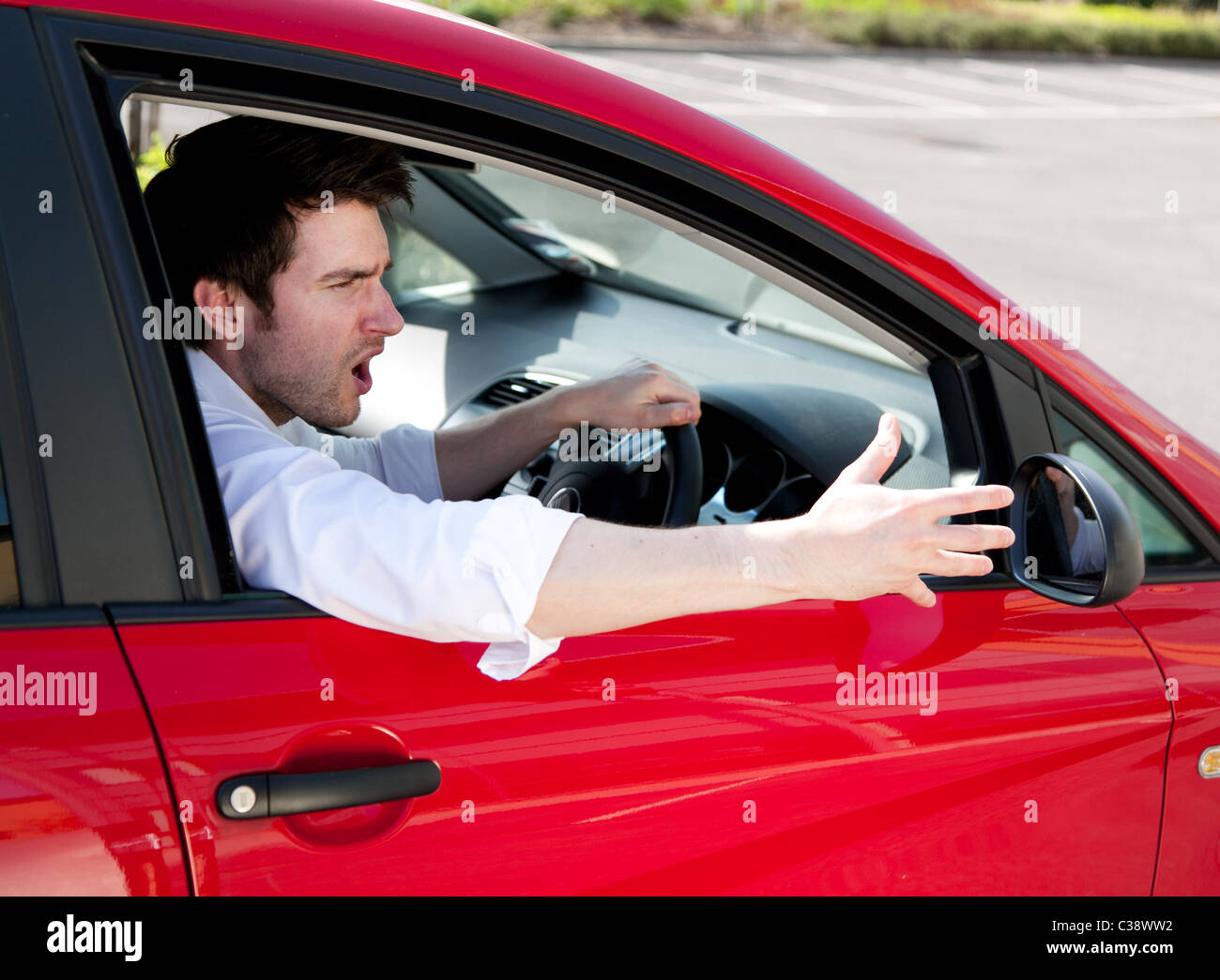 Man gesturing whilst driving car Stock Photo