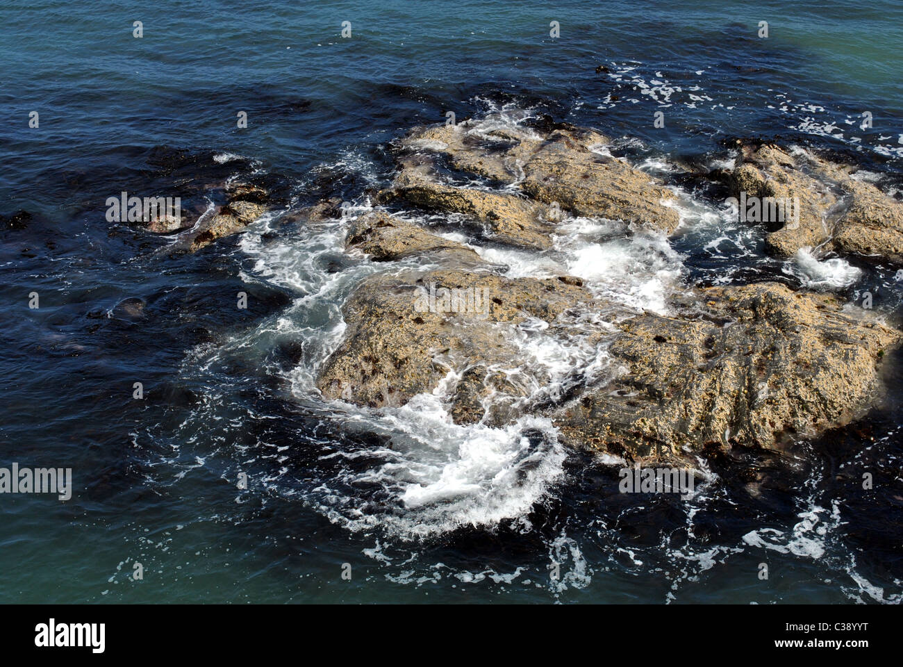 waves crashing over rocks in the irish sea Stock Photo