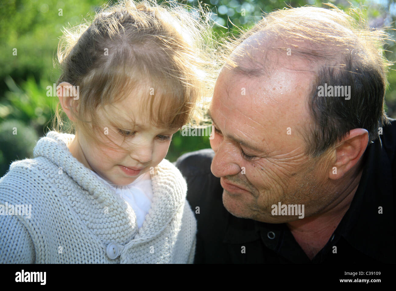 3 yr old girl with her grandfather Stock Photo