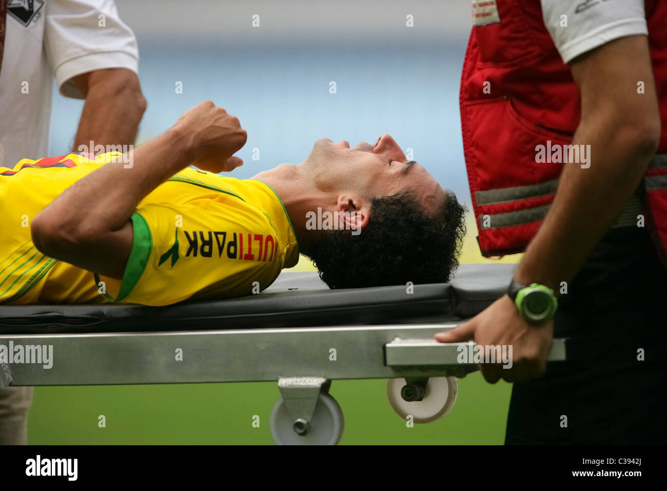 Injured football player being carried on a stretcher Stock Photo