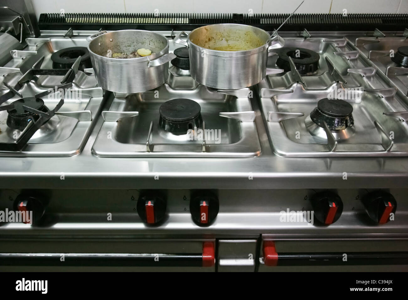 Pots on industrial stove of modern restaurant kitchen Stock Photo Alamy