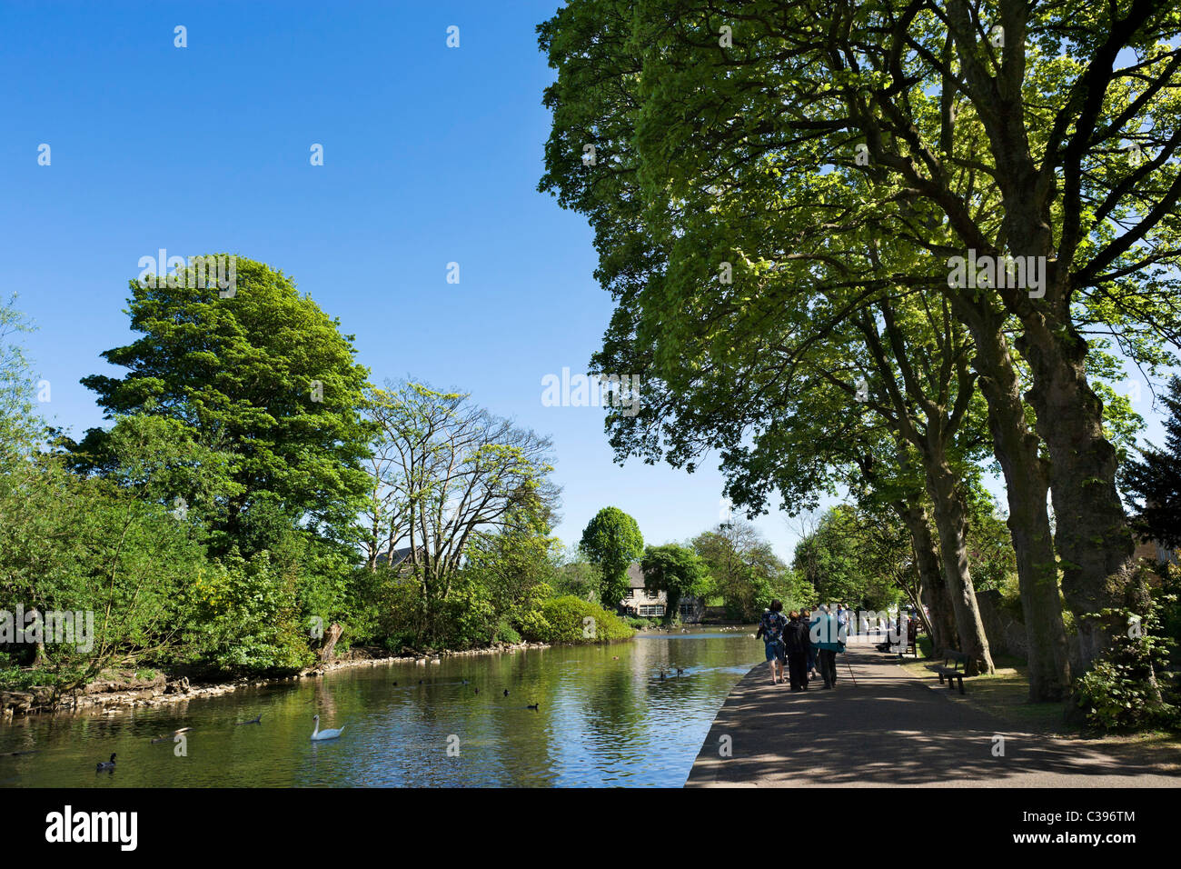 The banks of the River Wye in the village of Bakewell on early May Bank Holiday weekend, The Peak District, Derbyshire, UK Stock Photo