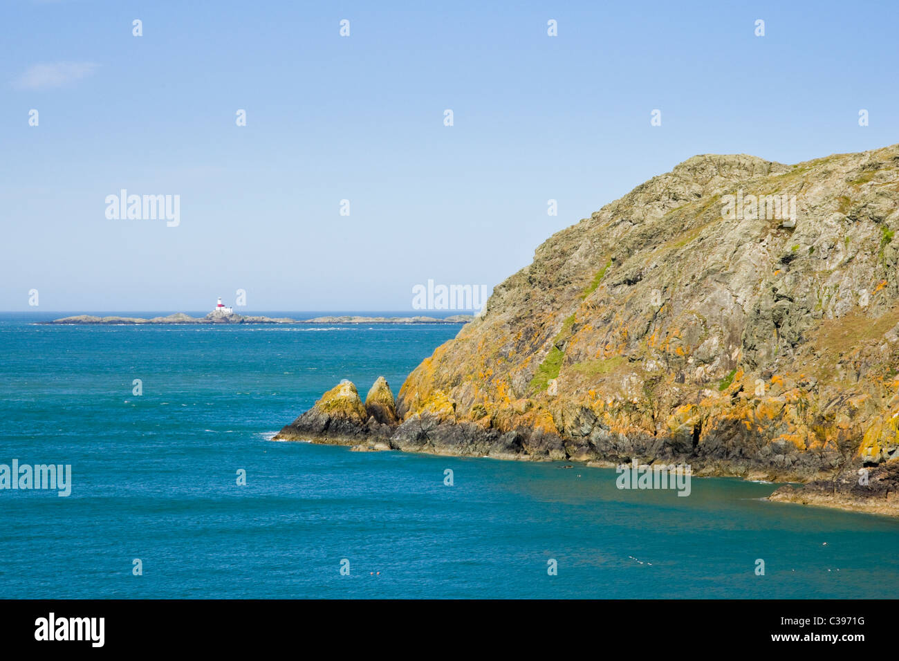 View to cliffs and the Skerries trial site for underwater turbines. Carmel Head, Isle of Anglesey, North Wales, UK. Stock Photo