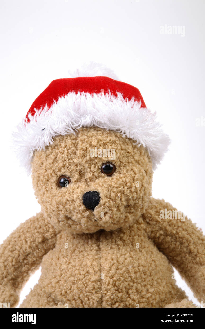 A teddy bear with a Christmas hat Stock Photo - Alamy