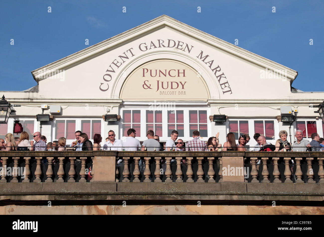 Drinkers on the balcony of the famous Covent Garden Market public house, the Punch & Judy. Stock Photo