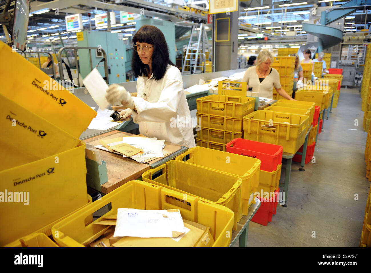Women sorting letters in a postal sorting centre, Berlin, Germany Stock Photo