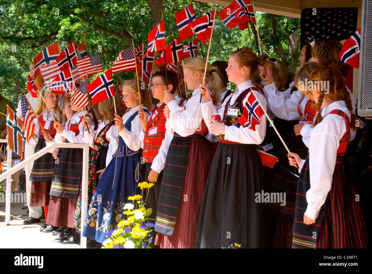 Children celebrating Norway Day waving Norwegian and American flags at Minnehaha Park. Minneapolis Minnesota MN USA Stock Photo