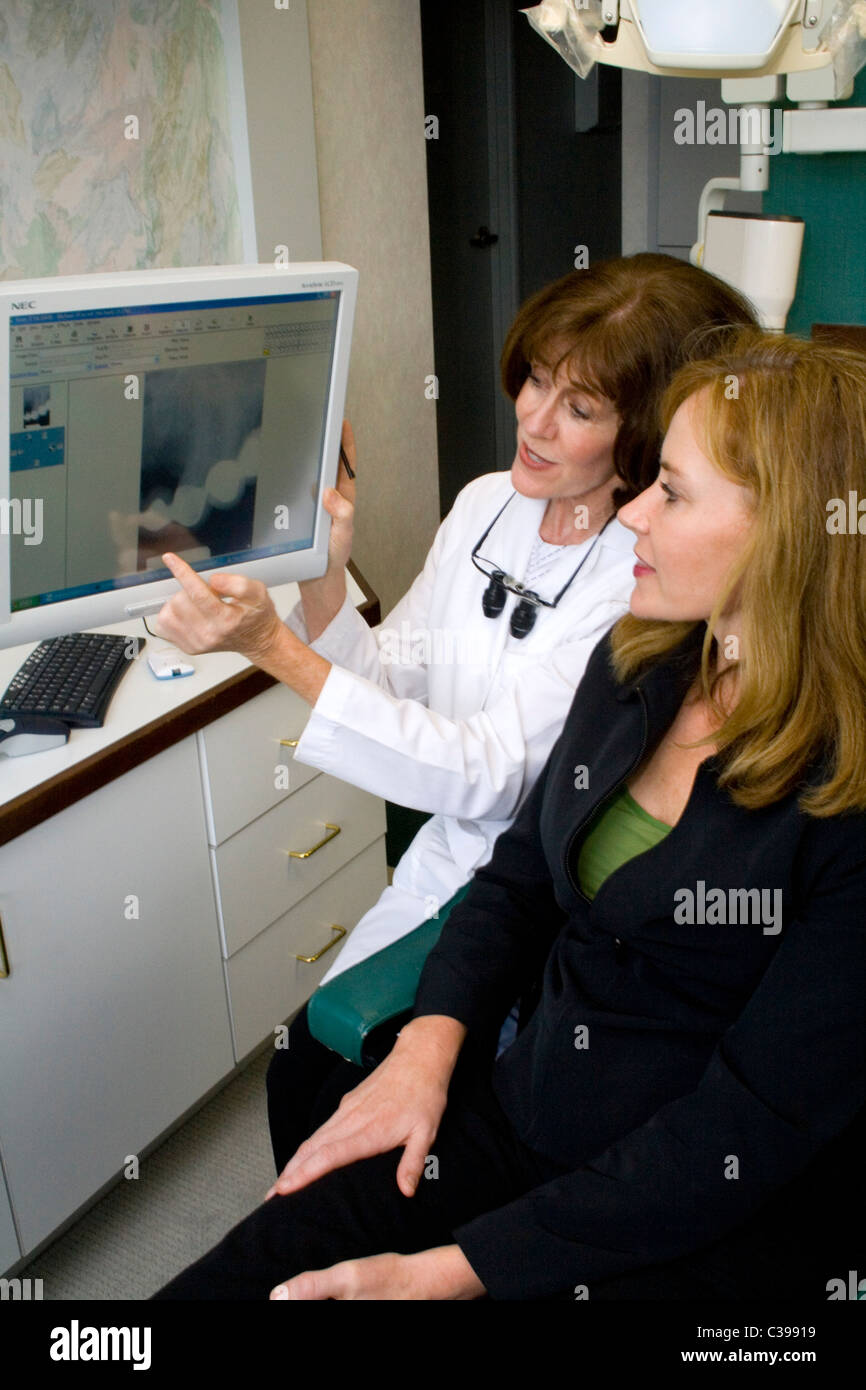 Dentist helping a patient understand a dental treatment using a