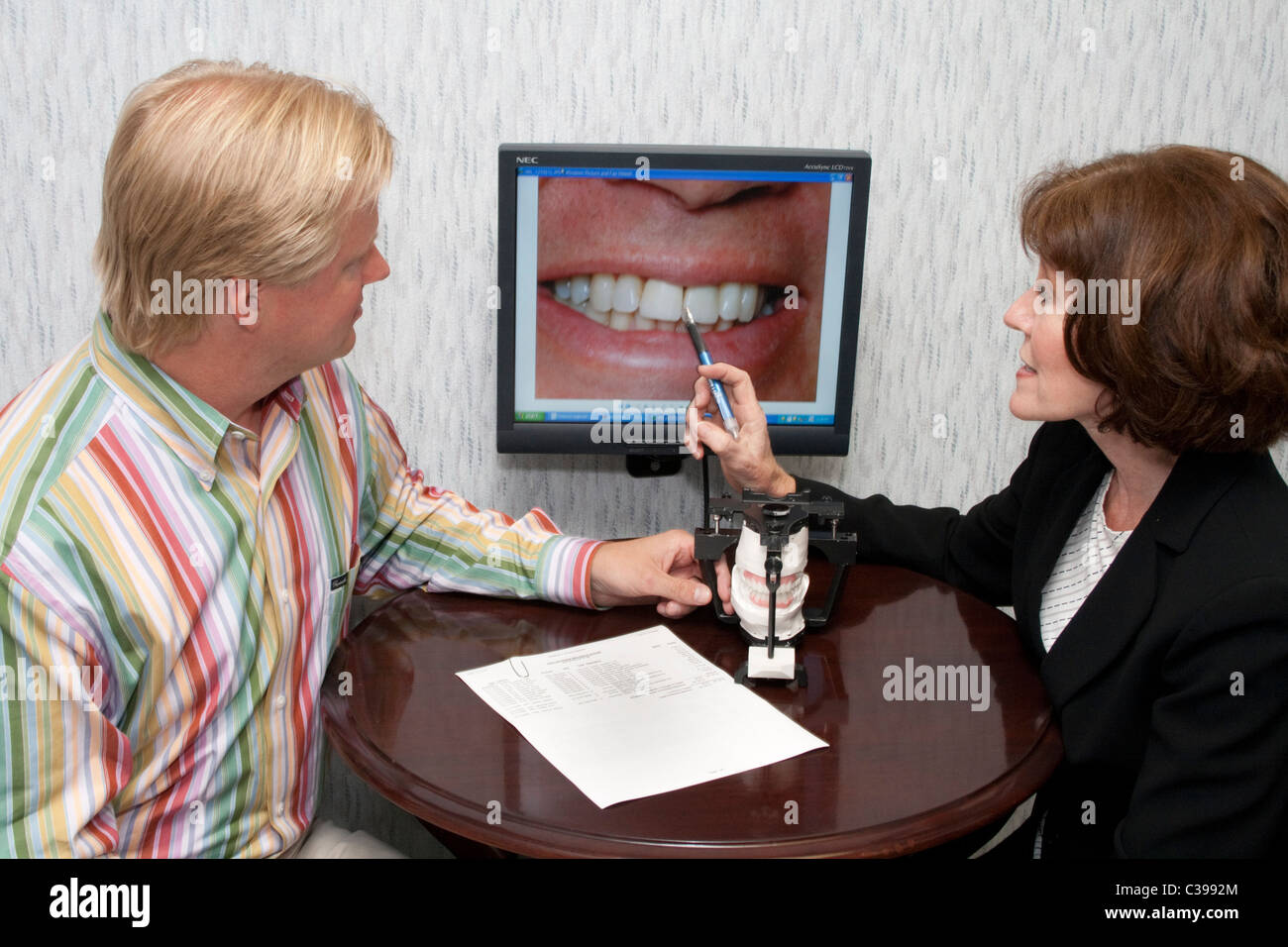 Woman dentist advising patient about cosmetic dental work. St Paul