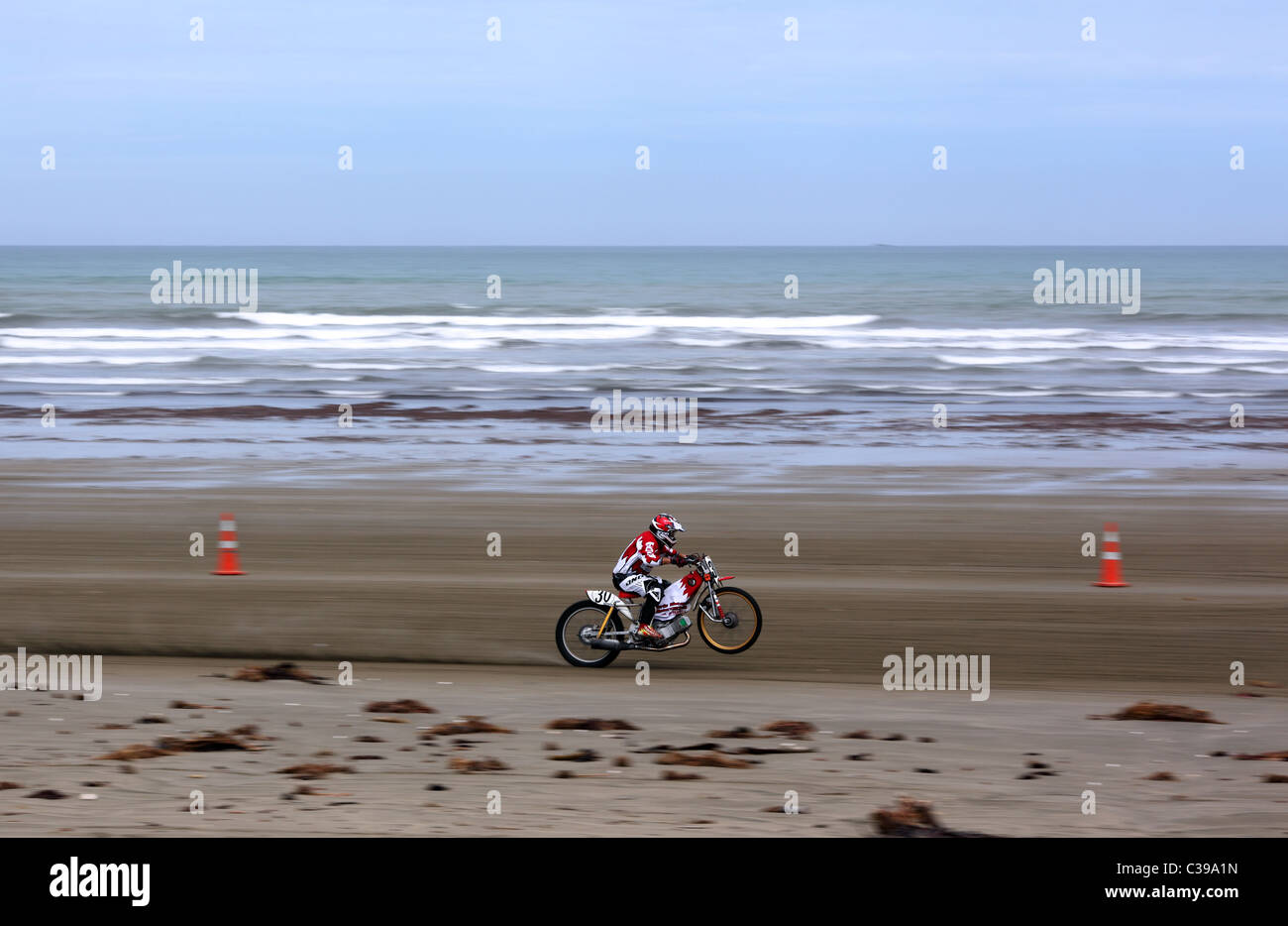 Participant in motorcycle beach race during the Burt Munro Challenge on Oreti Beach in Invercargill, New Zealand Stock Photo