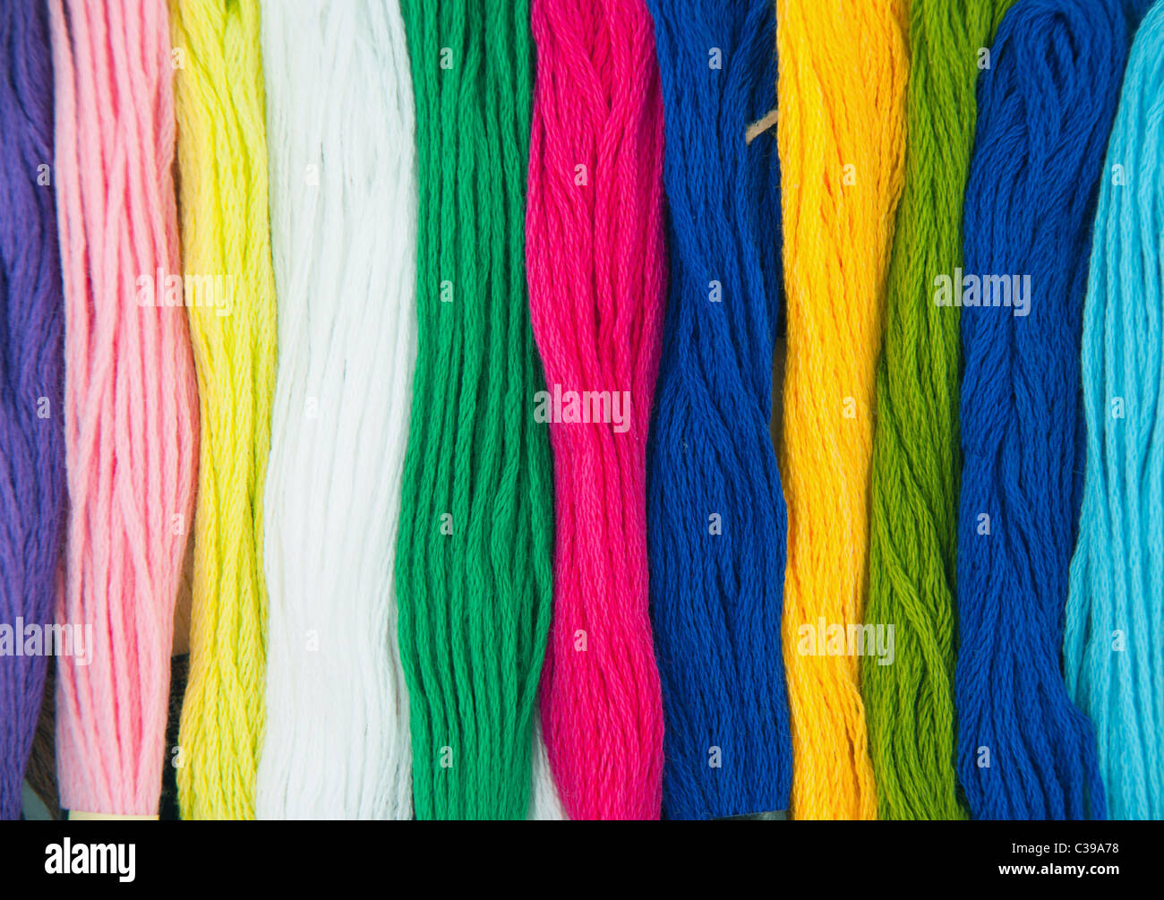 colorful threads set with needle as needlework background Stock Photo