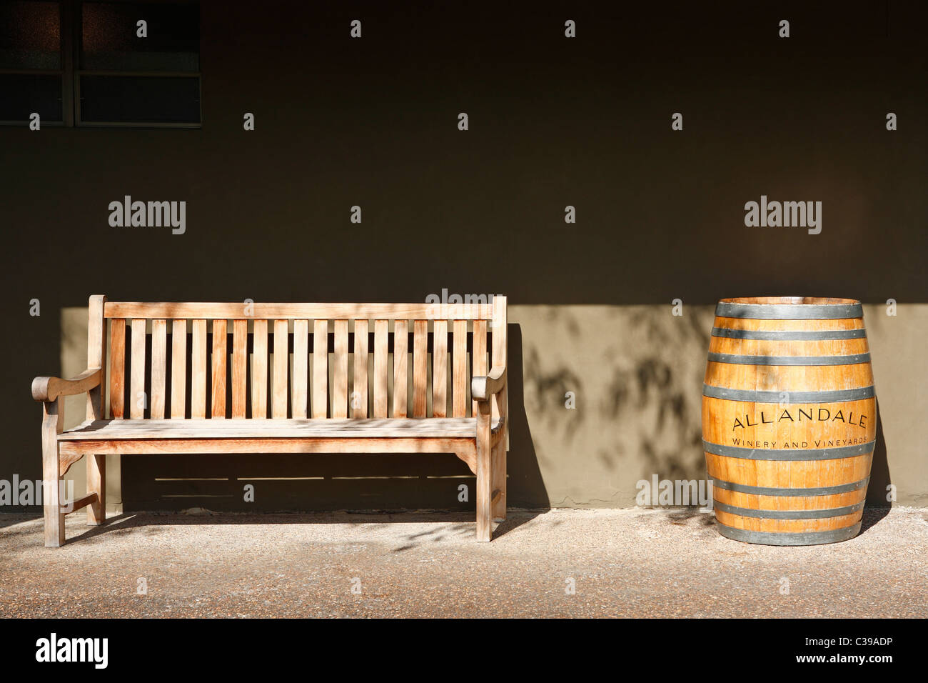a wooden seat and an old wine barrel at Allandale Winery and Vineyard. Pokolbin, Hunter Valley, New South Wales, Australia Stock Photo