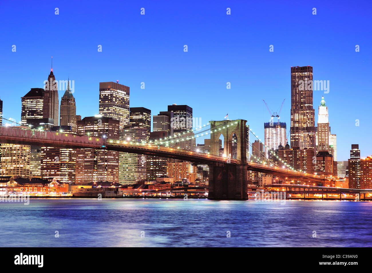 Brooklyn bridge with New York City Manhattan downtown skyline at dusk ...