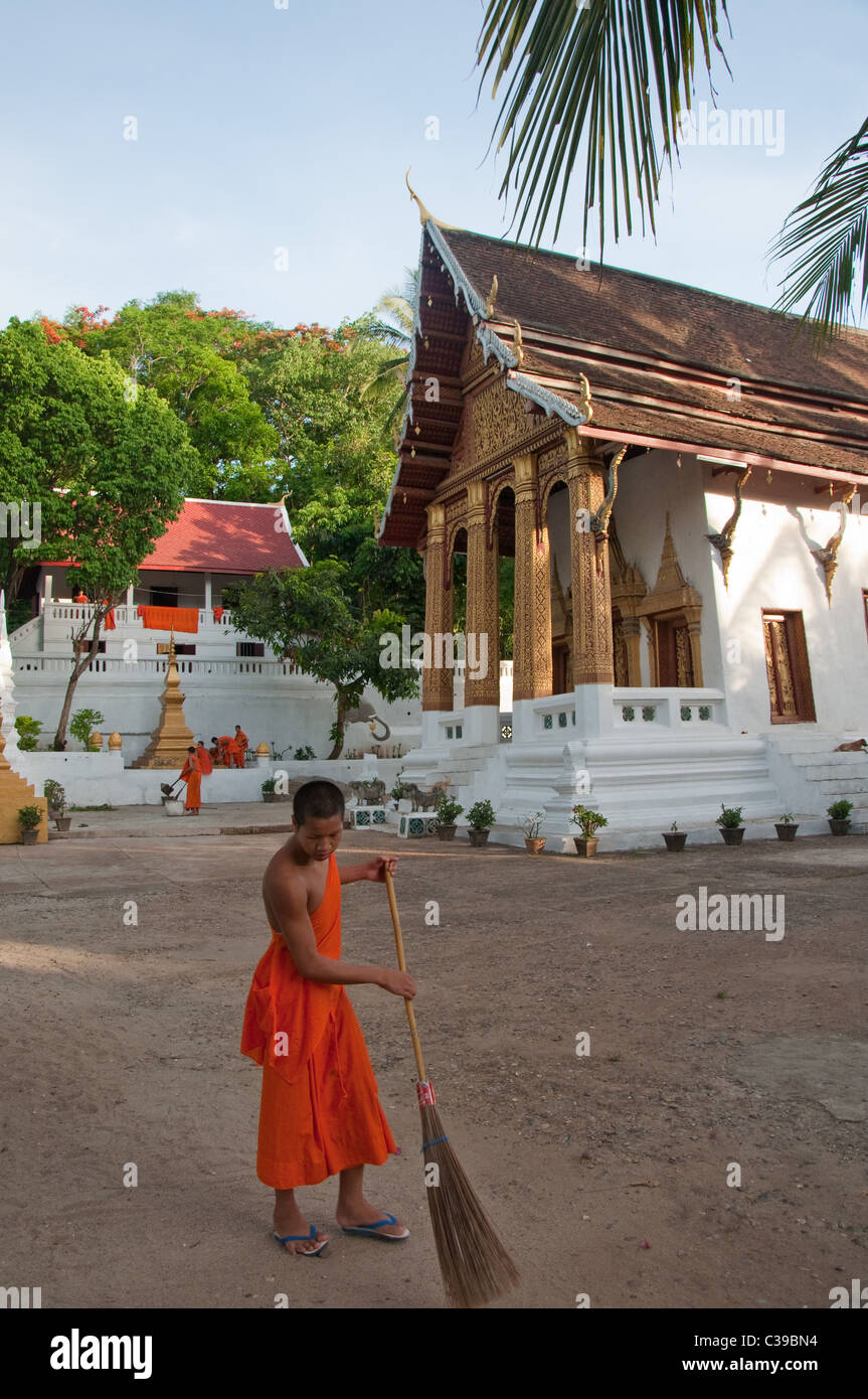 Monks cleans their Buddhist temple in Luang Prabang, Laos Stock Photo