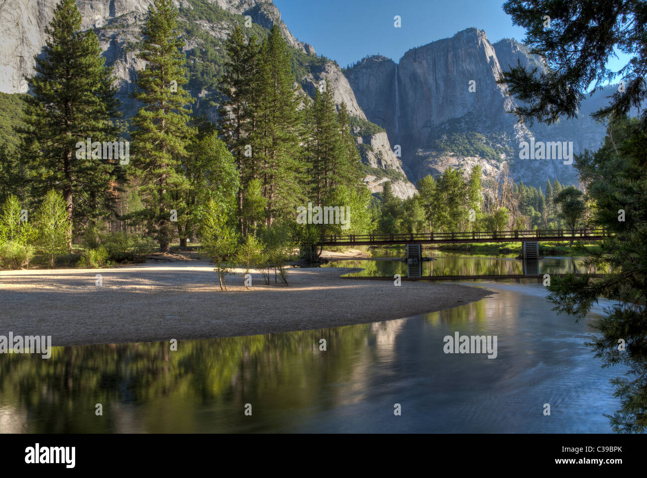 View of Upper Yosemite Fall and Swinging Bridge from the banks of the