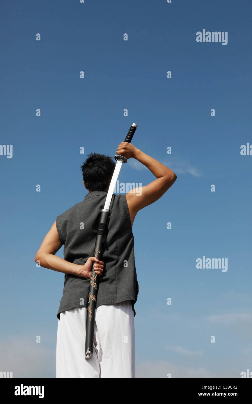 Man holding sword hires stock photography and images Alamy