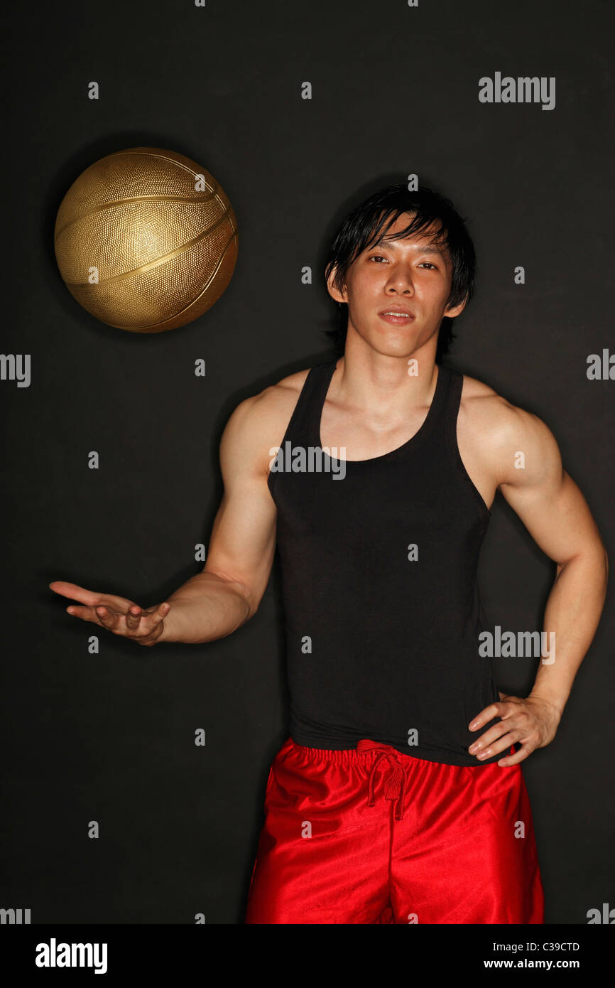 Chinese man throwing up basketball Stock Photo Alamy