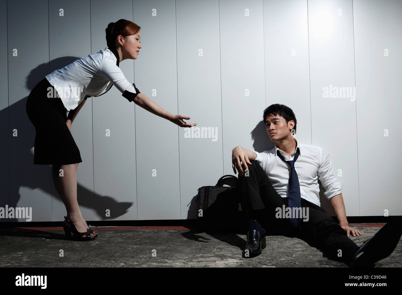 Woman offering help man sitting hi-res stock photography and images - Alamy