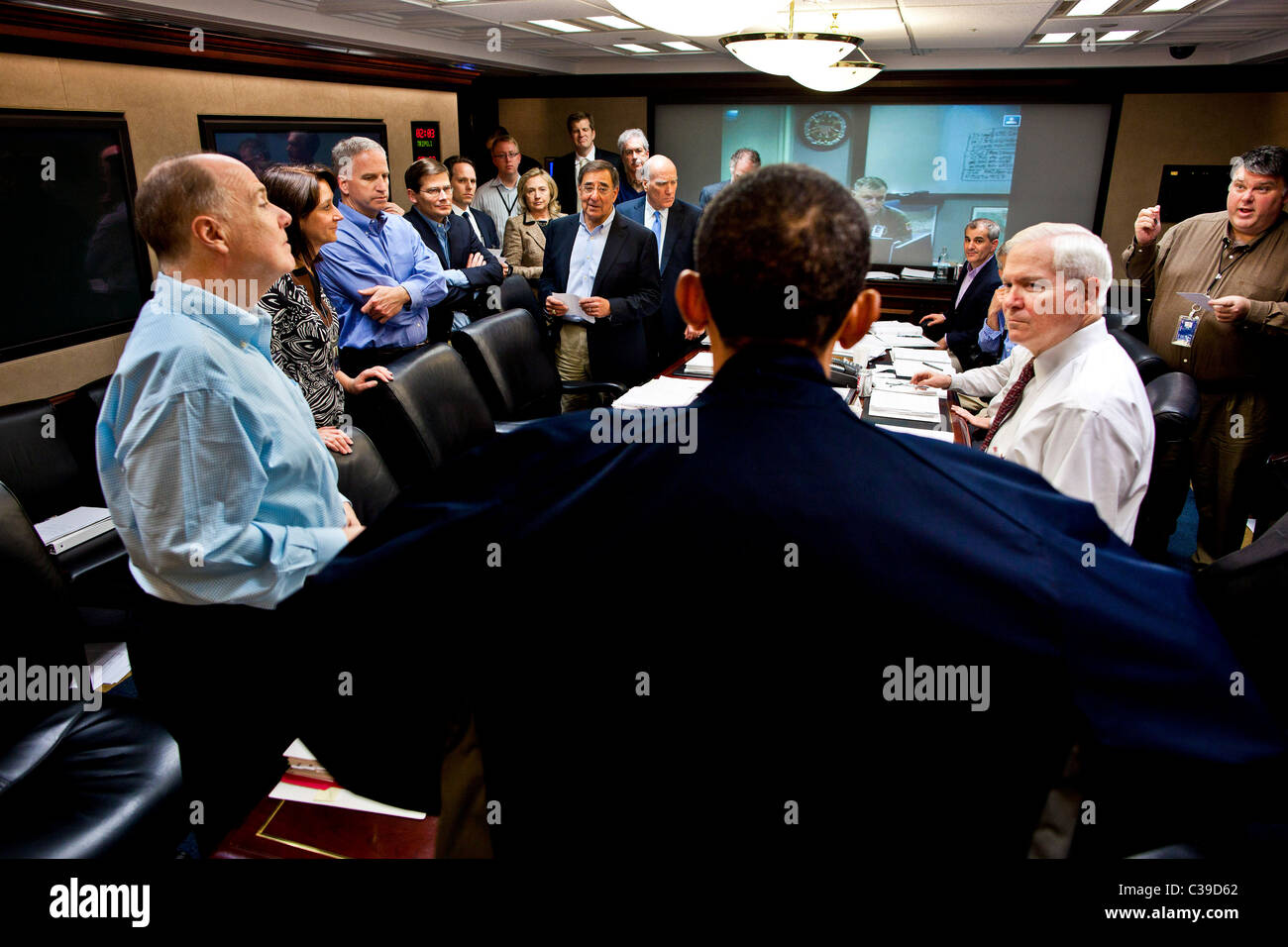 President Barack Obama talks with members of the national security team at the conclusion of one in a series of meetings discuss Stock Photo