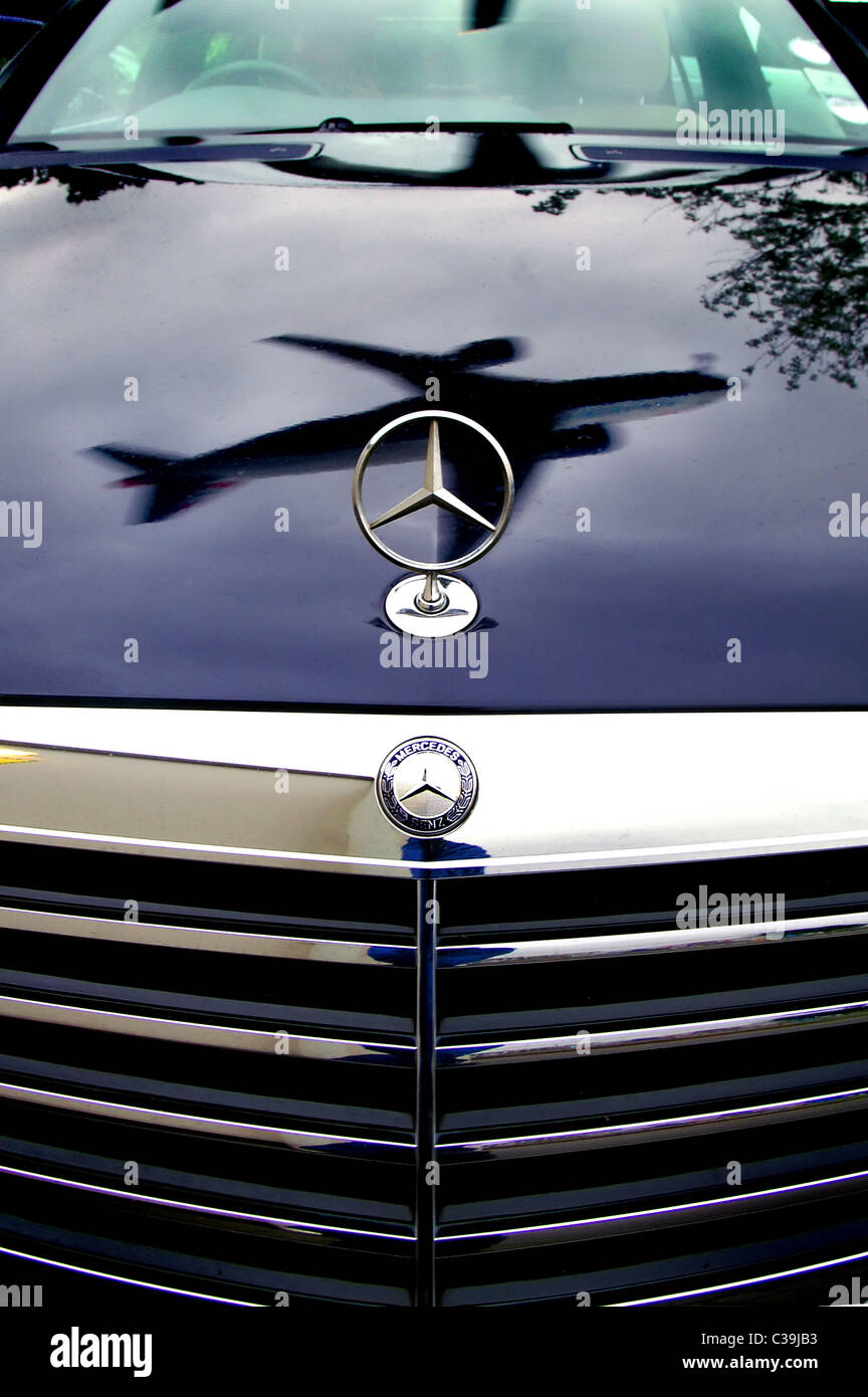 An aeroplane reflected on the bonnet of a Mercedes car parked in close near  to Heathrow International Airport Stock Photo - Alamy