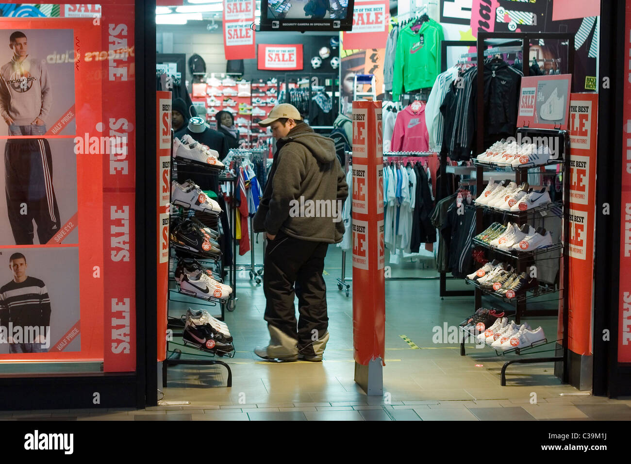 A shopper heads into a JD Sports store having spotted a deal during the sales. Stock Photo