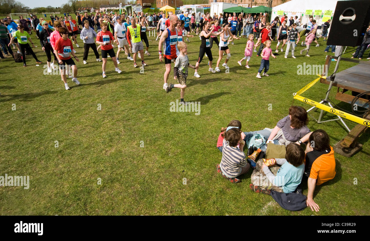 group of people limbering uip before local running event Stock Photo