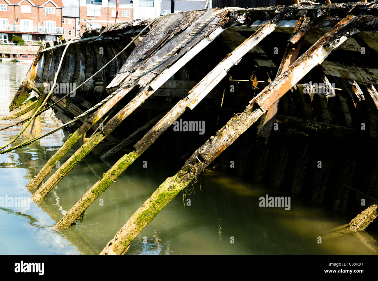 A rotting wooden boat on its side in the River Arun at Littlehampton