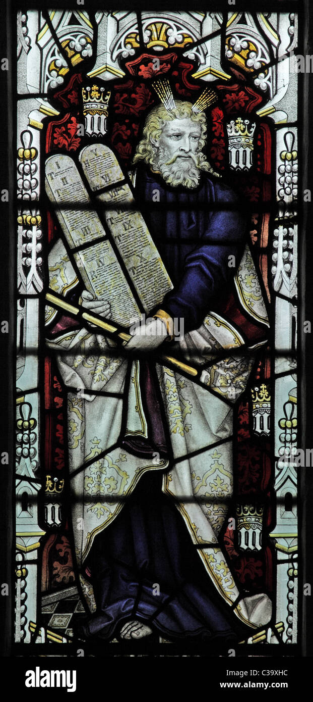 A stained glass window by C E Kempe & Co. depicting Moses holding the Ten Commandments Stock Photo