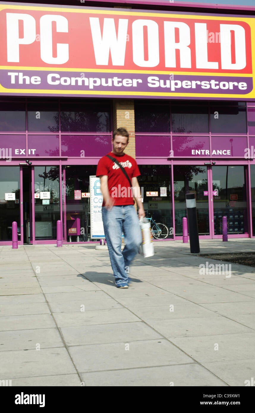 A PC World customer leaving a store with his purchase Stock Photo Alamy