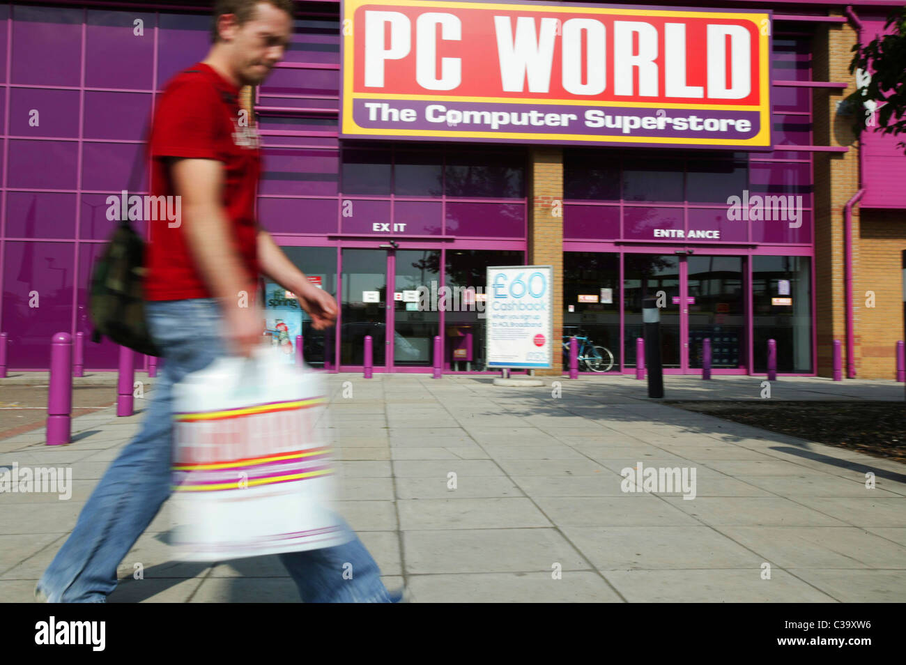 A PC World customer leaving a store with his purchase Stock Photo Alamy