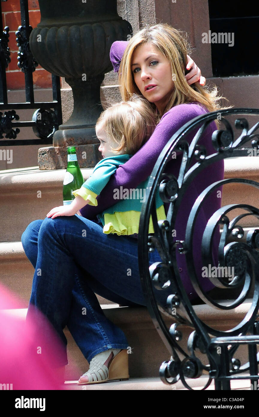 Jennifer Aniston holds a child while on the set of her new film ‘The