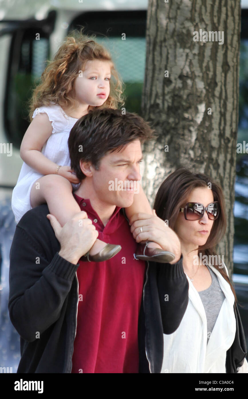 Jason Bateman carries his daughter, Francesca, on his shoulders while walking with his wife Amanda Anka during a break at the Stock Photo