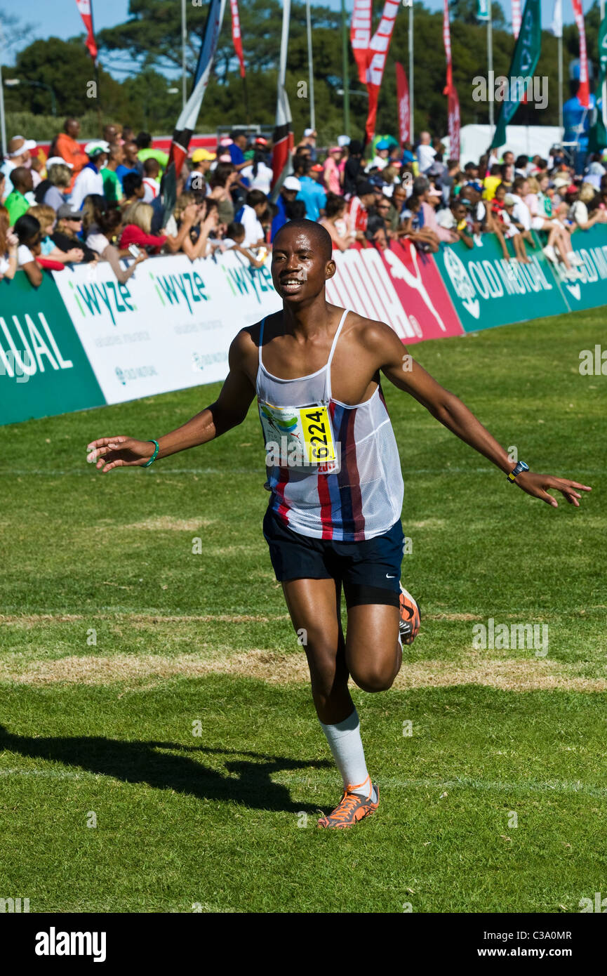 Runner celebrating at the finish of the 5km Fun Run celebrating, Two Oceans Marathon, Cape Town, South Africa Stock Photo