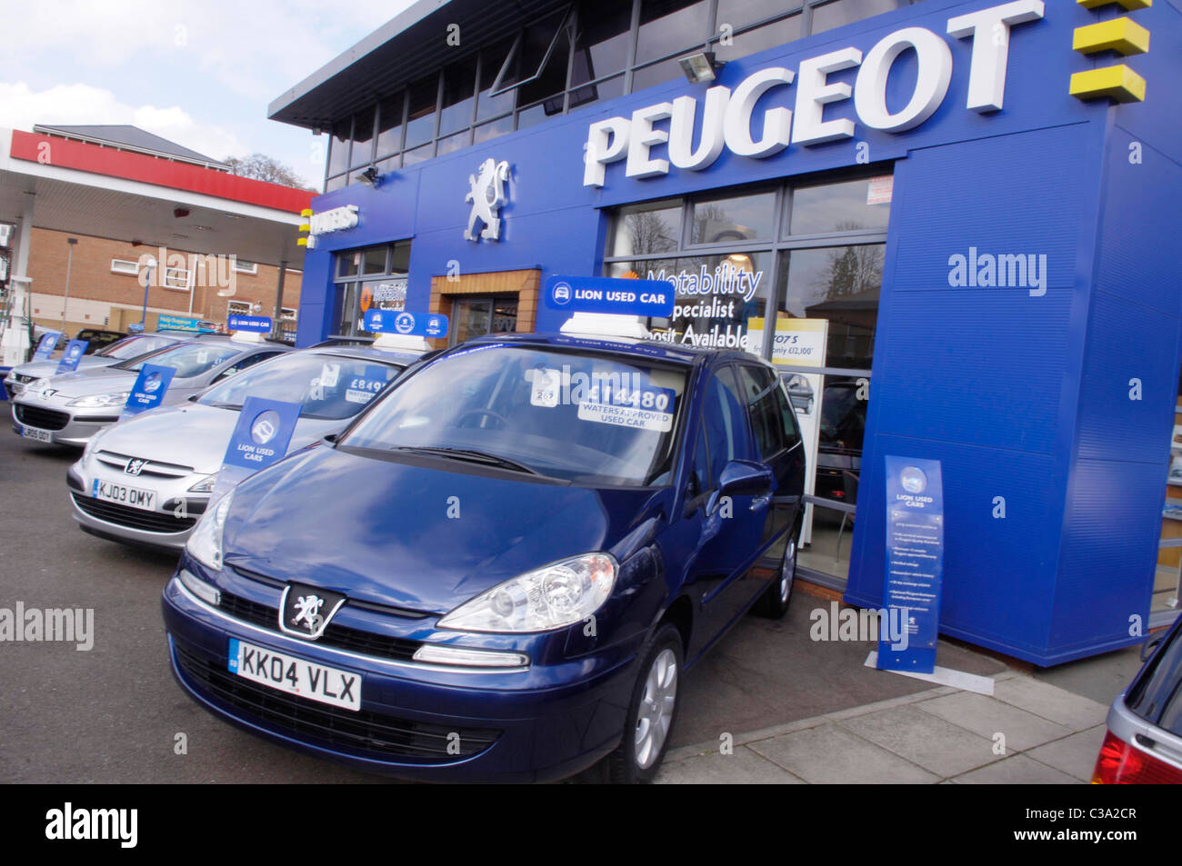 Second hand cars on display outside a Peugeot car dealership. Stock Photo