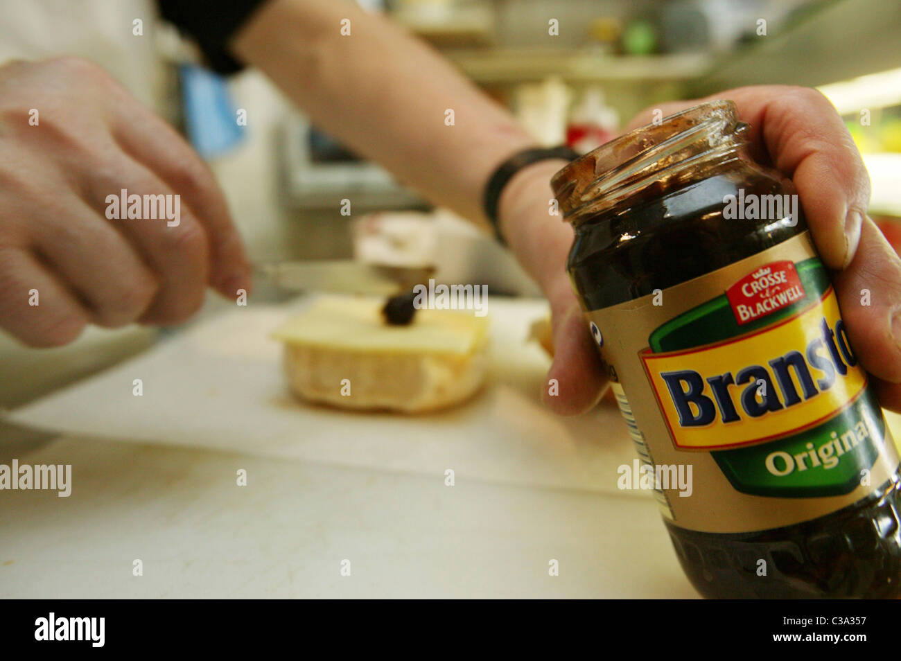 A man making a sandwich using Branston Original Pickle; a Premier Foods